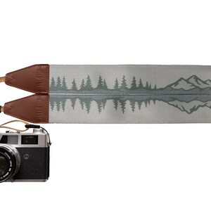 camera strap with printed mountains and trees