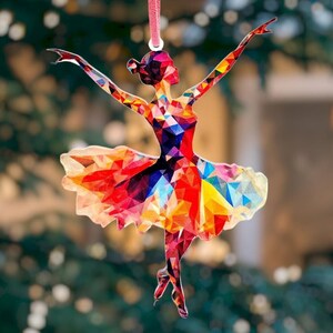 May include: A colorful, geometric ballerina ornament with a red, orange, yellow, blue, and green color scheme. The ornament is made of a thin, lightweight material and is perfect for hanging on a Christmas tree or other festive decor.