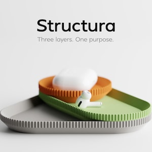 May include: A modern product display featuring three stacked, colorful trays. The top tray is orange, the middle is green, and the bottom is gray. A white charging case and earbuds rest on the trays. The word "Structura" is at the top.