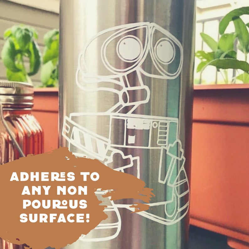 May include: A stainless steel water bottle with a white vinyl decal of the robot character WALL-E from the Disney Pixar movie WALL-E. The text "ADHERES TO ANY NON POROUS SURFACE!" is on the bottle.
