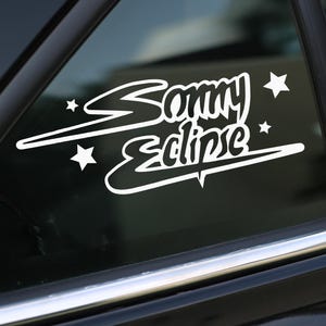 May include: White vinyl decal with the text "Sammy Eclipse" in a stylized font. The decal features a white star on each side of the text and a white swoosh design.