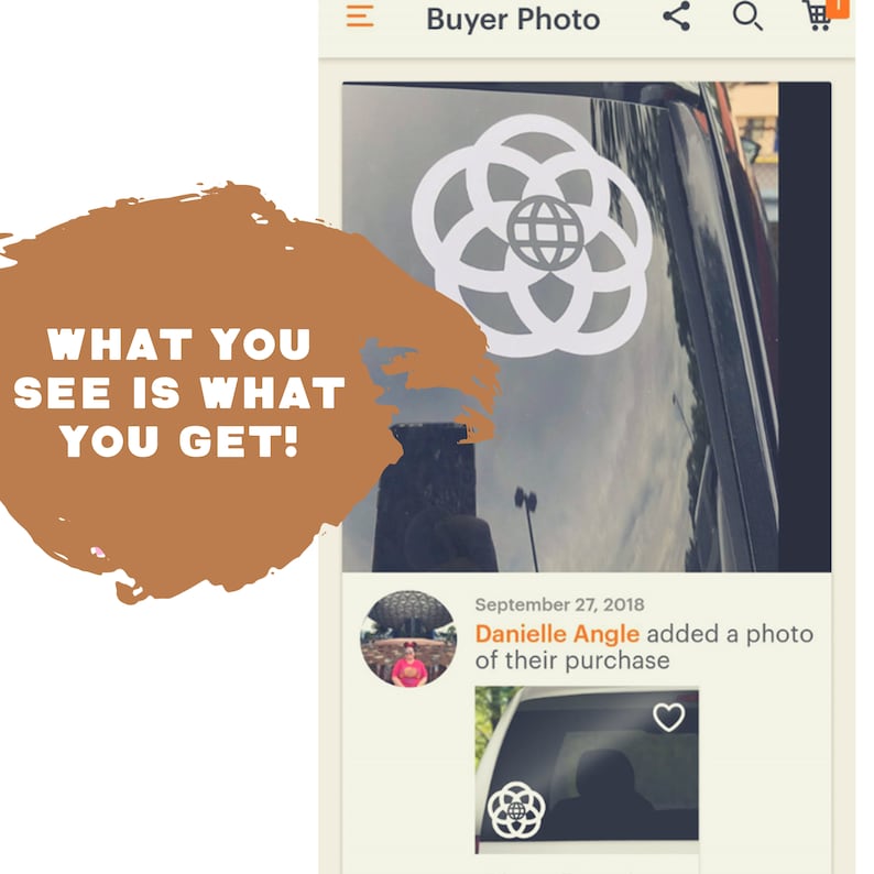 May include: A white vinyl decal of the Walt Disney World logo, featuring a circle with a globe inside and four interlocking rings. The decal is applied to the back window of a car. The image includes the text "September 27, 2018 Danielle Angle added a photo of their purchase."
