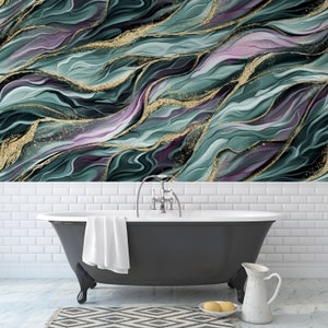 May include: A bathroom scene featuring a black clawfoot bathtub with a white towel, a white pitcher, and a decorative rug. The wall is adorned with a teal, purple, and gold abstract design, creating a luxurious and artistic ambiance.