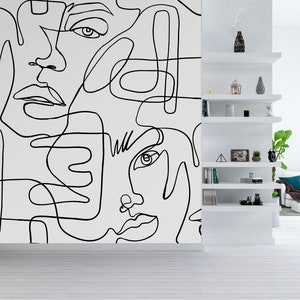 A large black and white faces wall mural in continuous line drawing style, perfect for creating a bold statement wall in a modern living room, loft space, gallery style hallway or contemporary office interior.