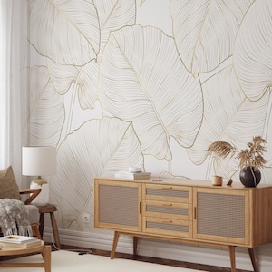 Gold line art leaf wallpaper with large tropical leaves; removable peel-and-stick design for living rooms or bedrooms.