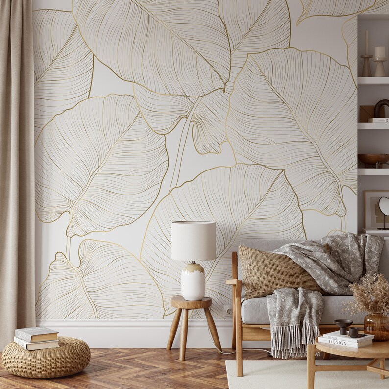 Gold line art leaf wallpaper with large tropical leaves; removable peel-and-stick design for living rooms or bedrooms.