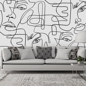 Abstract face line drawing wallpaper mural featuring expressive black outlines on white. Great choice for renters and homeowners wanting a contemporary feature wall without major renovation or construction work in the room.