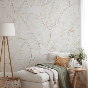 Minimal botanical wall mural—oversized banana leaves in printed gold lines on a clean white background; modern neutral look.