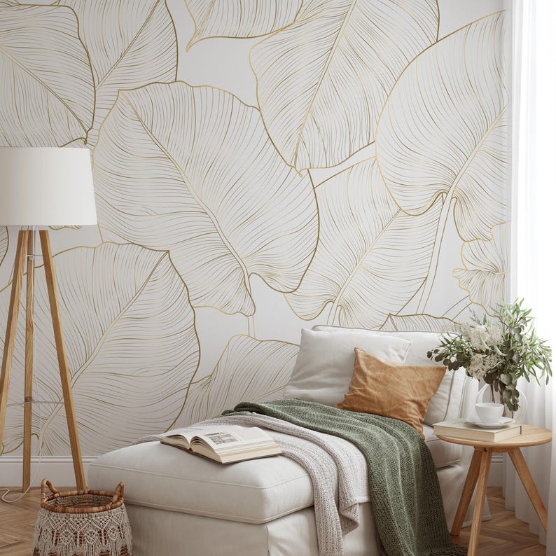 Minimal botanical wall mural—oversized banana leaves in printed gold lines on a clean white background; modern neutral look.