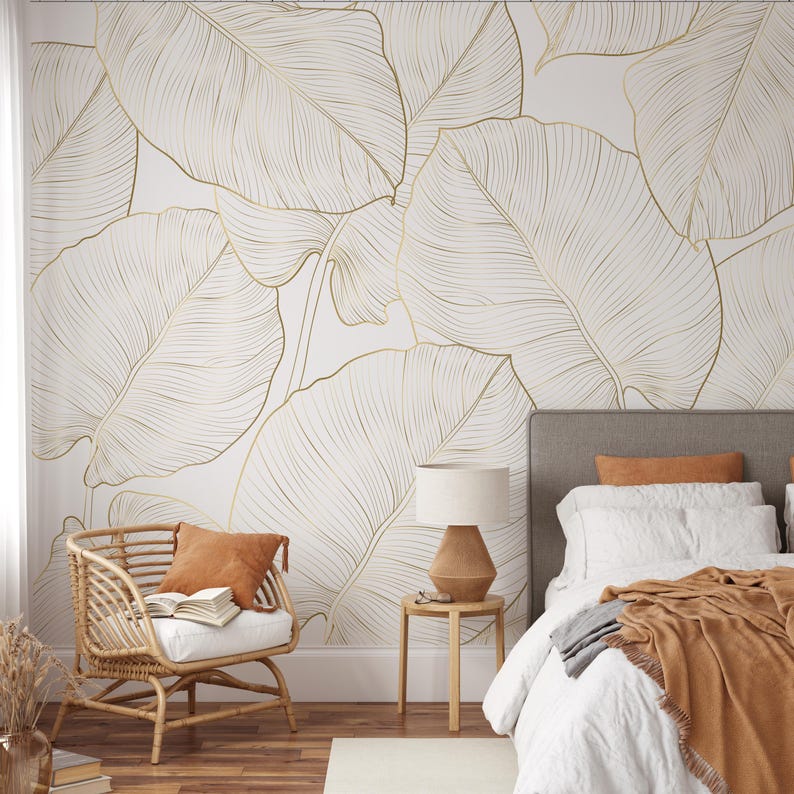 Neutral white wallpaper with large banana leaves outlined in faux gold line art; removable peel-and-stick botanical mural.