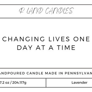 May include: A white label with black text that reads "RLAND CANDIES", "CHANGING LIVES ONE DAY AT A TIME", "HANDPOURED CANDLE MADE IN PENNSYLVANIA", "7.2 oz/204.117g", and "Lavender".