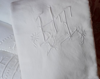 Fine linen metis HT hand embroidered monogrammed sheet, white work daisies running through the letters, ladder work top hem