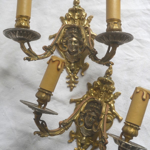 A pair of antique French 19th century heavy bronze and metal 2 armed wall sconces, putti/cherubs