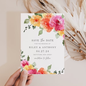 May include: Save the date card with watercolor floral design in shades of pink, orange, and yellow. The text reads "Save the Date for the wedding of Riley & Anthony 04.27.24 Smithtown, New Jersey invitation to follow."