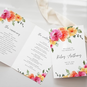 May include: Wedding ceremony programme with a floral design featuring pink, orange, and yellow flowers. The programme includes the order of events for the ceremony and reception. The text on the programme reads "the ceremony" and "the wedding".