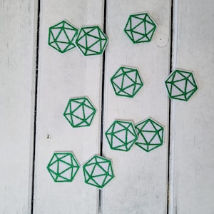 May include: Nine green and white embroidered iron-on patches shaped like a twenty-sided die.