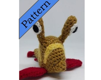 May include: A crocheted stuffed animal resembling a snail with a brown body, yellow stripes, red legs, and white eyes.