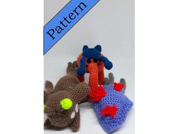 May include: Three crocheted stuffed animals. One is brown with green eyes, one is orange with red arms and a blue hat, and one is purple with red accents.
