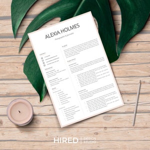 May include: A beige resume template with the name Alexia Holmes, Photographer & Journalist, at the top. The resume includes sections for contact information, education, experience, skills, and profile. The resume is designed with a minimalist aesthetic and features a subtle beige background.