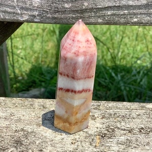 Rose calcite tower, natural carved stone