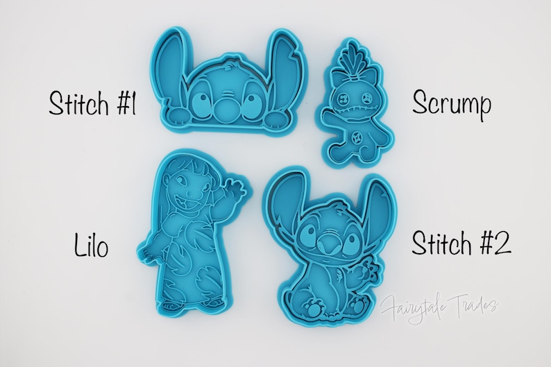 May include: Four teal-colored cookie cutters featuring characters from the animated film Lilo & Stitch. The cutters include Stitch #1, Scrump, Lilo, and Stitch #2. The names of the characters are written in black text next to each cutter.