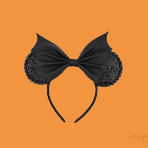 May include: Black headband with a bat-shaped bow and sequined ears. The bow is made of a satin-like material. The ears are round and covered in black sequins. The headband is black and has a curved shape. The background is orange.