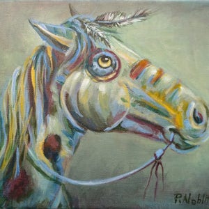 May include: An oil painting of a horse's head, featuring a colorful, abstract design. The horse is painted in shades of blue, yellow, and red, with a feather in its mane. The artwork has a textured appearance and is signed by the artist.