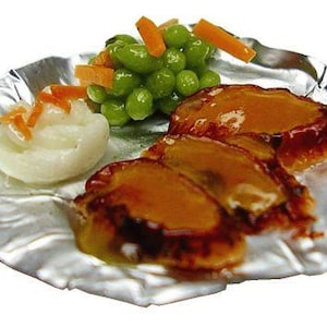 May include: A miniature food dish featuring glazed meat, green peas, carrots, and a white side dish, served on a silver foil plate. The arrangement suggests a complete meal, ideal for a dollhouse or miniature collection.