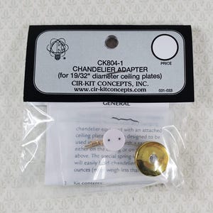 May include: A chandelier adapter kit in a clear plastic package. The black and white label reads "CHANDELIER ADAPTER" and "CIR-KIT CONCEPTS, INC.". The kit includes a white adapter plate and a gold-colored metal piece.