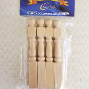 May include: A package of four unfinished wooden dollhouse balusters. The balusters are light brown and have a turned design. The package includes a blue and gold label that reads "International Miniatures by Classics" and "Quality Dollhouse Accessories."
