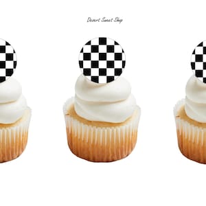 May include: Three cupcakes with white frosting and a black and white checkered circle on top. The cupcakes are in white paper liners and have a light brown cake base. The text "Desert Sweet Shop" is in the top center.