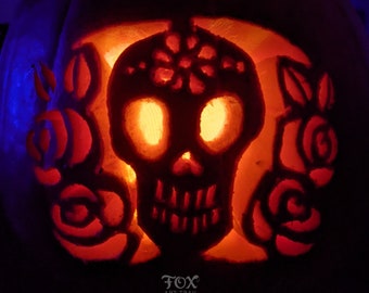 May include: A carved pumpkin with a glowing orange skull and floral designs. The skull has a detailed design with a flower on the forehead and two eye sockets. The pumpkin is lit from inside, creating a spooky and festive atmosphere.