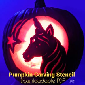 May include: A carved pumpkin with a unicorn design illuminated from within. The pumpkin features a star and crescent moon design. Text at the bottom reads "Pumpkin Carving Stencil Downloadable PDF". The background is a dark blue.