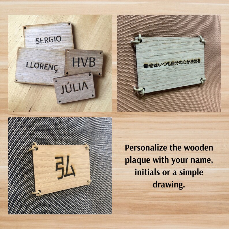 May include: Wooden plaques with different text and designs, including "SERGIO", "LLOREN&Ccedil;", "HVB", "J&Uacute;LIA", and "幸せはいつも自分の心が決める". The plaques are made of light brown wood and have holes for string or rope to hang them. The text is burned into the wood. The plaques are on a wooden background. The text "Personalize the wooden plaque with your name, initials or a simple drawing." is below the plaques.