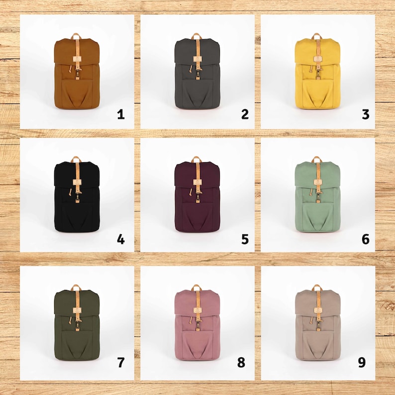 May include: Nine different colored canvas backpacks with leather straps and buckles. The backpacks are arranged in a 3x3 grid.