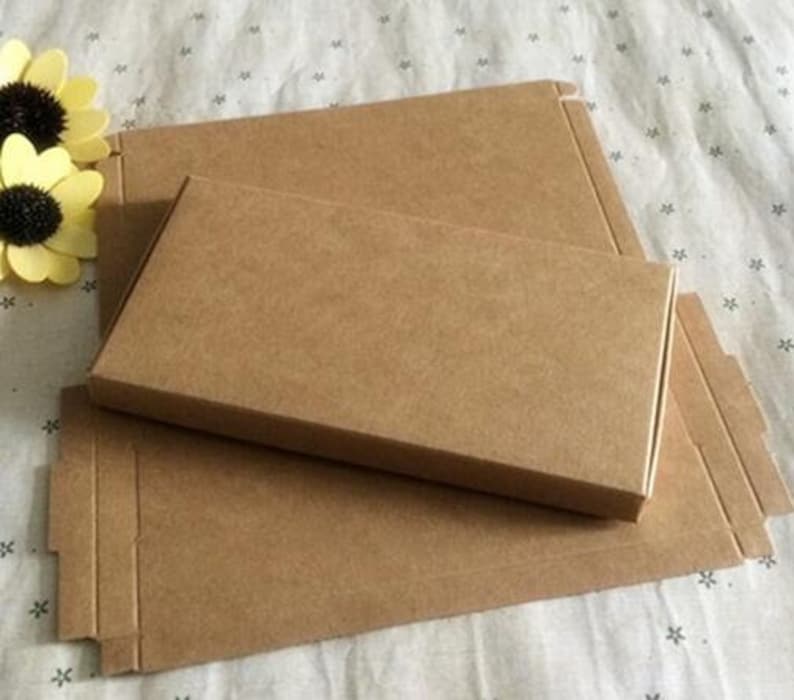 May include: Two brown cardboard boxes, one nested inside the other. The larger box has a flap on the side. The smaller box is slightly smaller than the larger box.