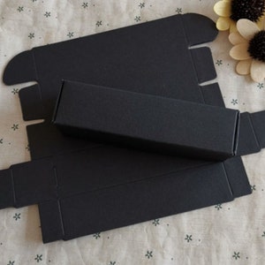 May include: Black cardboard box with a separate inner box. The box is folded flat and ready to be assembled.
