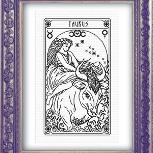 May include: Black and white line art illustration of a woman riding a bull with the word "Taurus" at the top of the image. The image is framed in a decorative frame.