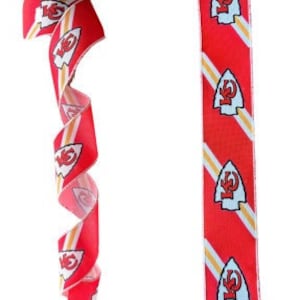 May include: Red and white ribbon with a repeated pattern of the Kansas City Chiefs logo. The ribbon is curled and laid flat.