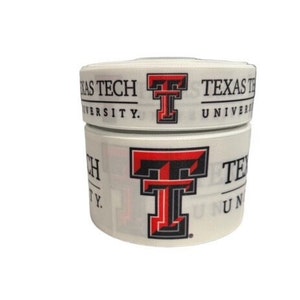 May include: White ribbon with the Texas Tech University logo and the letters "TT" in red and black. The ribbon is wrapped around itself.