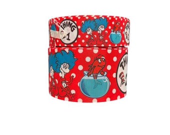 May include: Red and white polka dot ribbon with a repeating pattern of Thing 1 and Thing 2 characters from the book "The Cat in the Hat".