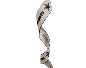 May include: A beige ribbon with a blue star and the word "COWBOYS" printed on it. The ribbon is curled into a spiral shape.