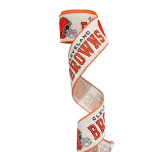 May include: White ribbon with the Cleveland Browns logo and the words "Cleveland Browns" printed in orange. The ribbon is curled and the logo is a football helmet.