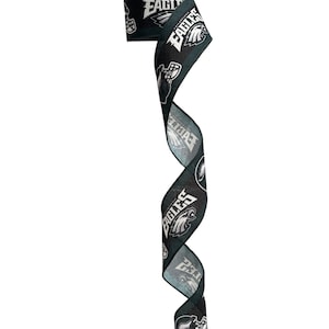 May include: Black and green ribbon with a white Philadelphia Eagles logo and the words "Philadelphia Eagles" printed on it.