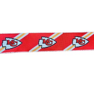 May include: Red, white, and gold ribbon with a repeating pattern of the Kansas City Chiefs logo. The logo is a white arrowhead with the letters "KC" in red.
