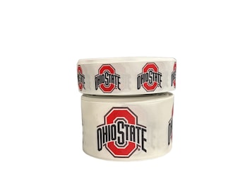 May include: White ribbon with the Ohio State logo printed on it. The logo is red and black with the words "Ohio State" written underneath.