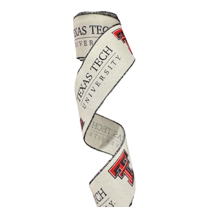 May include: A cream-colored ribbon with the words "Texas Tech University" printed in black and a red and black "TT" logo. The ribbon is curled and ready to be used for wrapping gifts or decorating.