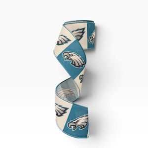 May include: A decorative ribbon featuring a repeating pattern of teal and cream-colored squares. Each teal square displays a stylized eagle head logo in white, grey, and black. The ribbon is curled into a spiral shape, showcasing the alternating design.