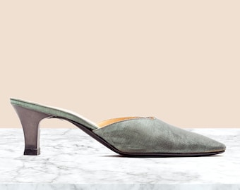May include: A pair of green satin heeled mules with a pointed toe.