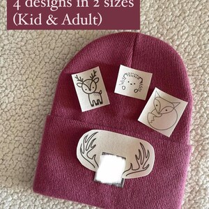 May include: A burgundy beanie with four iron-on patches featuring a deer, hedgehog, fox, and antlers. The text "You will get: 4 designs in 2 sizes (Kid & Adult)" is visible in the top left corner of the image.